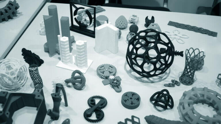 Abstract models printed by 3d printer close-up. Objects printed on a 3d printer on a white table. Progressive modern additive technology. Concept of 4.0 industrial revolution